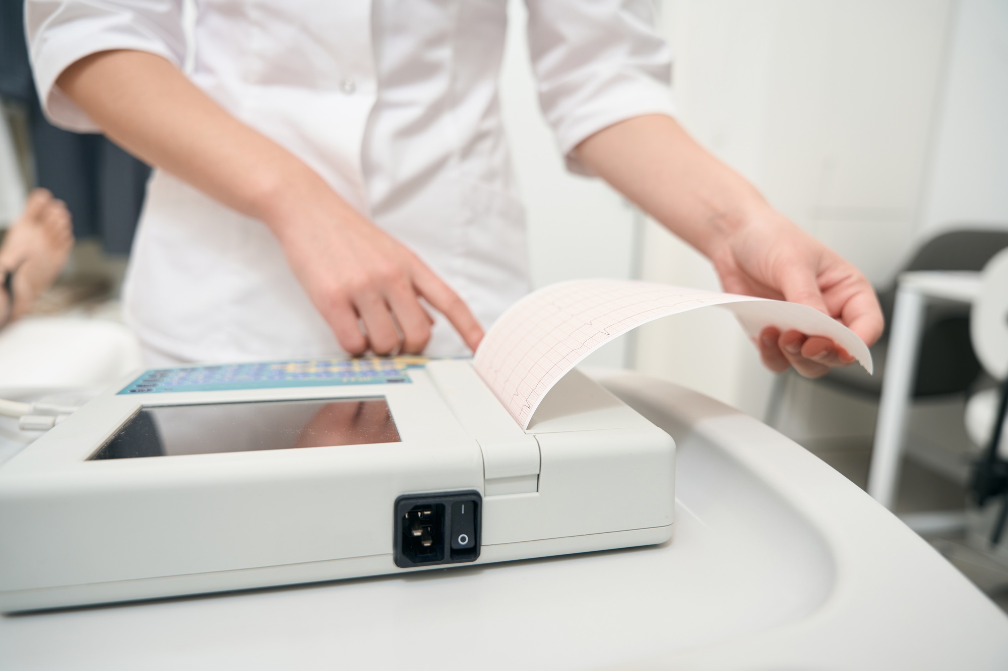 Detail photo of medicine worker is examining cardiology data in medicine clinic